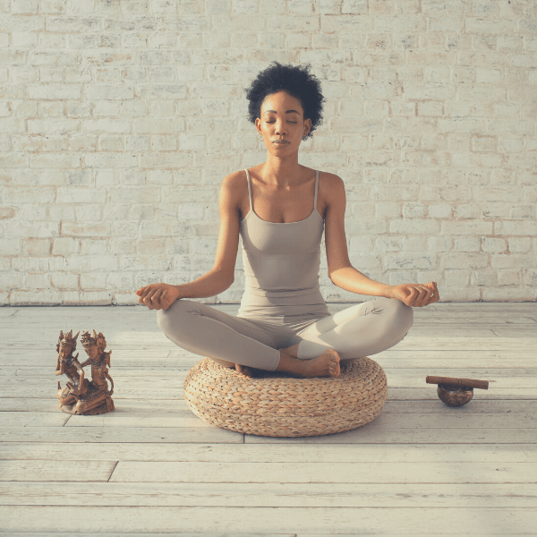 junge afroamerikanische Frau mit vollen Haaren meditiert